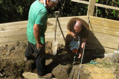 Setting steel restraining rods. Having the wall fall over is best avoided.