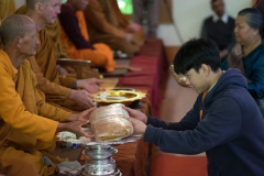 Luang Por Poi receives a robe.