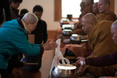 Ajahn Natawat a regular visitor to Bodhinyanarama receives an offering.