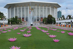 The front entrance to the conference hall. Vesak lotuses cover the lawn.