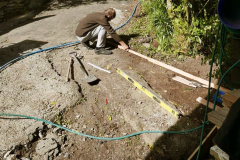 Lindsay preparing the workshop entrance for a long awaited patch of concrete.