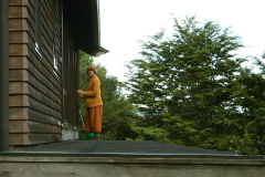Ajahn Dta - on his birthday - cleaning the dana sala windows.