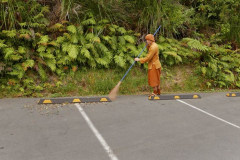 Ajahn Dta making a clean sweep of the car park.