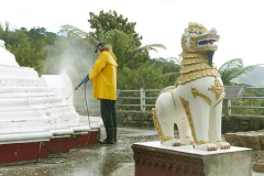 Drew water blasting the stupa in preparation for painting.