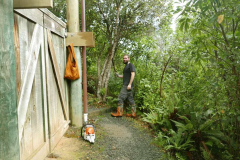 Bryce with machete poised ready to start clearing wheeled access to the vihara basement level.