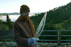 Venerable Thanavaro holds an ice scimitar lifted from the tarp covering the stupa. Yes it was a cold morning.