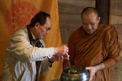 Ajahn Dta receives a food offering.