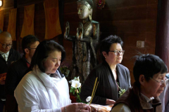 Carrying offerings and chanting Itipi so... the lay community circumambulate the sala.
