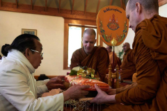 Uncle Som offers the Kathina cloth.