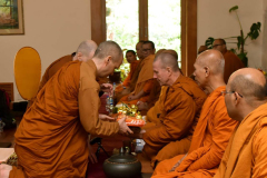 The cloth is offered to Ajahn Kusalo.