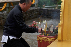 Chang braves the rain to make offerings. Sadhu!