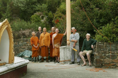 All gathered to lower the pole in the west corner of the stupa enclosure. Many strings attached.