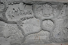 Three large stone panels surround the stone pillar depicting Luang Por Chahs life (work not finished). Center ajahn Chah with ajahn Sumedho and Khemmanando.