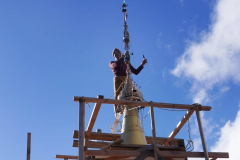 On a ladder resting on planks which straddle the handrail our intrepid ajahn effects repairs.