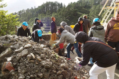 The rubble from the concrete slab and old stone wall is removed.