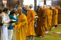 Luang Por Poi leads the sangha on alms round in the cloister.