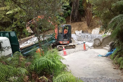 The lower section of the landslide has been levelled and drained. Gabion baskets are being built to retain any future slippage.