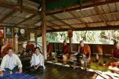 Thai tudong: lay stewards and sangha in the sala at meal time.