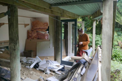Ajahn Jo with hammer in de-nail mode? The Garden kuti almost ready for some digging to get the floor all on one level.