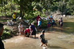 A new road has been cut into the monastery. The project is to cast a concrete road out of the river. Villagers digging gravel-sand out of the river.