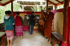 Alms is offered in a small pavilion on the edge of the village.
