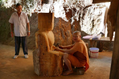 One of the monks working on carving a buddha image.
