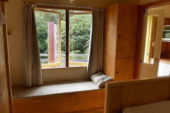 Just inside the entrance of Raja kuti - bed right window seat storage lockers kitchen right.