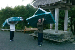 The newly ordained Anagarika Ryan and Jamie carrying mattresses to kutis for the retreat.