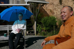 Anagarika Ryan and Ajahn Joe enjoy a bright winters day on the bhikkhu vihara patio.