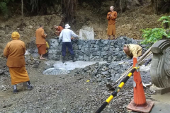 Putting the finishing touches to the gabion retaining wall at the base of the landslide.