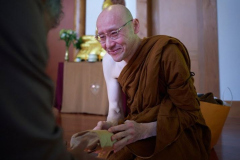 As a fully ordained samanera venerable Appamado receives some offerings from the laity.