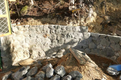 The patio stone wall at Ajahns kuti slowly progresses.