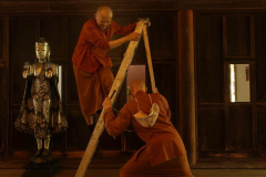 Venerable Appamado steadies the ladder for Ajahn Thitasippo.