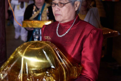 Sarina circumambulating the sala with her kathina offering.