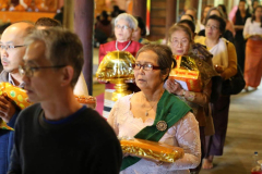 Robes and requisites are carried in cirucumambulation around the sala prior to being offered to the assembled sangha.