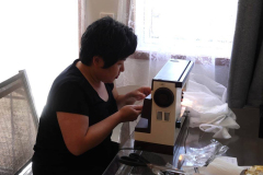 Arunee putting some finishing touches on the new curtains.