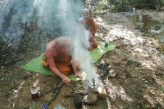 We are next to a small stream and tea is being prepared. Starting a fire with no paper or accelerant is a smoky affair.