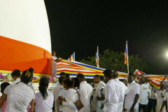 Following the drummers a flag is unwound and wrapped around the stupa. This took place many times during the evening.