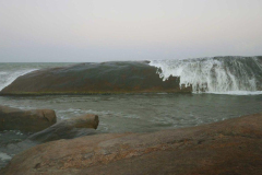 One single rock forms a dramatic barrier to the waves to offer another sheltered bathing pool.