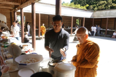 Food on three sides of the cloister being offered to the sangha.