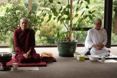 Ayya Abhisamma and Mae Chee Nuk quietly waiting in the dana sala for the meal time bell.
