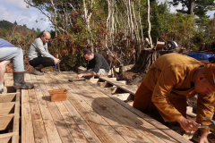 Shaun carefully measures the spacing of the deck boards.