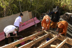 Nuk and Vipha working on getting the track grade right. The monks are building the kuti sub-floor.