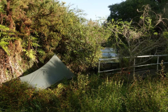 Tudong: Camped lakeside by some kind of flood control thing.