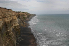 Tudong: A rugged coastline runs south.