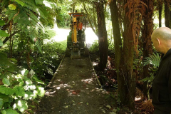 The digger just fits. Making its way to form the track up to Bruces new kuti.