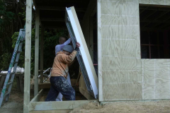 Anagarika McBain and Bruce wrestling the door into the new kuti in the lay residents zone.