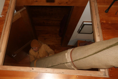The carpets are brought down from the sala attic in preparation for Vesak.