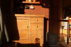 The totara cupboard front in Ajahn Kusalos kuti gleams in the late afternoon sun.