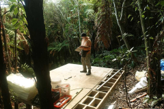 Bruce has his thinking cap on planning the next step for the new lay kuti; across the stream above the flat area.